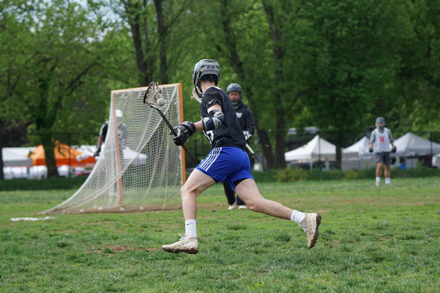 Lacrosse player running near the goal
