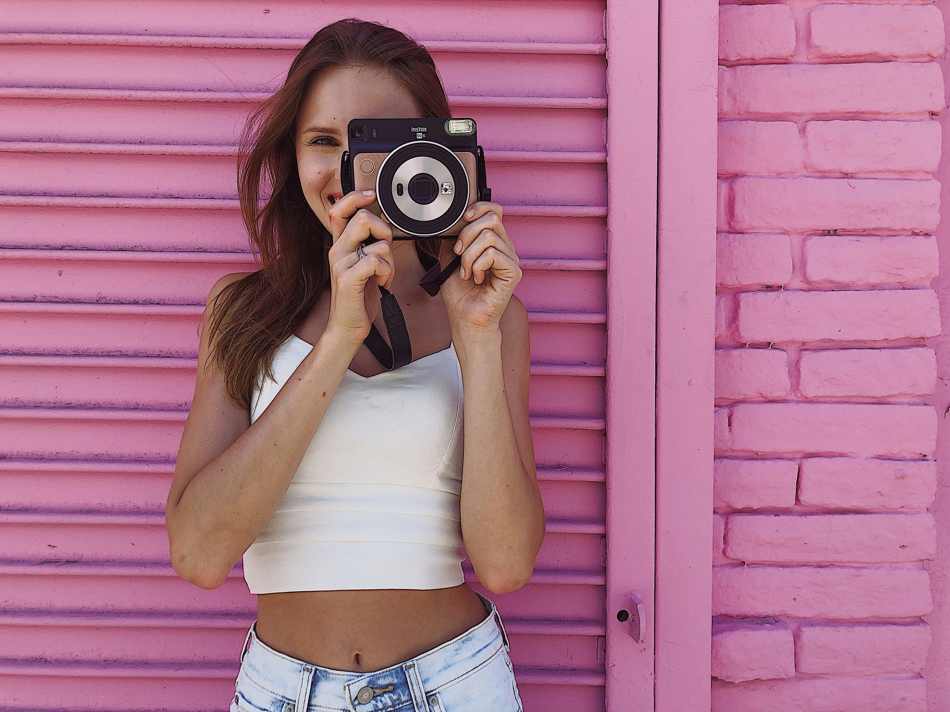Stylish female Instagram influencer posing confidently outdoors