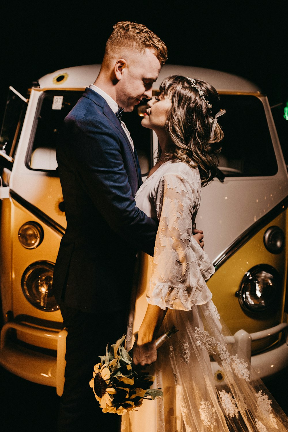 bride and groom near vehicle