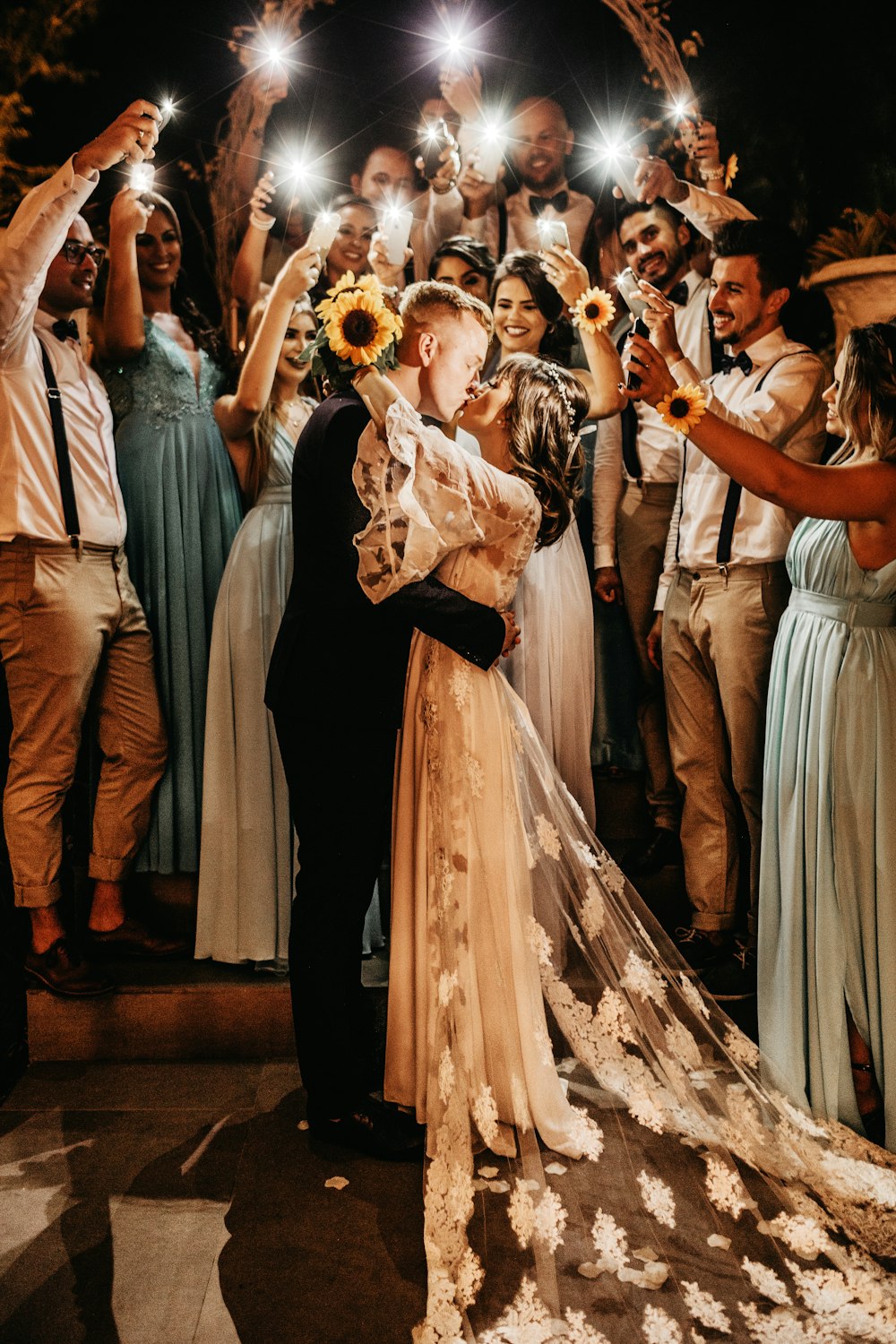 man and woman kissing in front of people