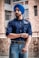man wearing blue denim dress shirt and blue turban standing