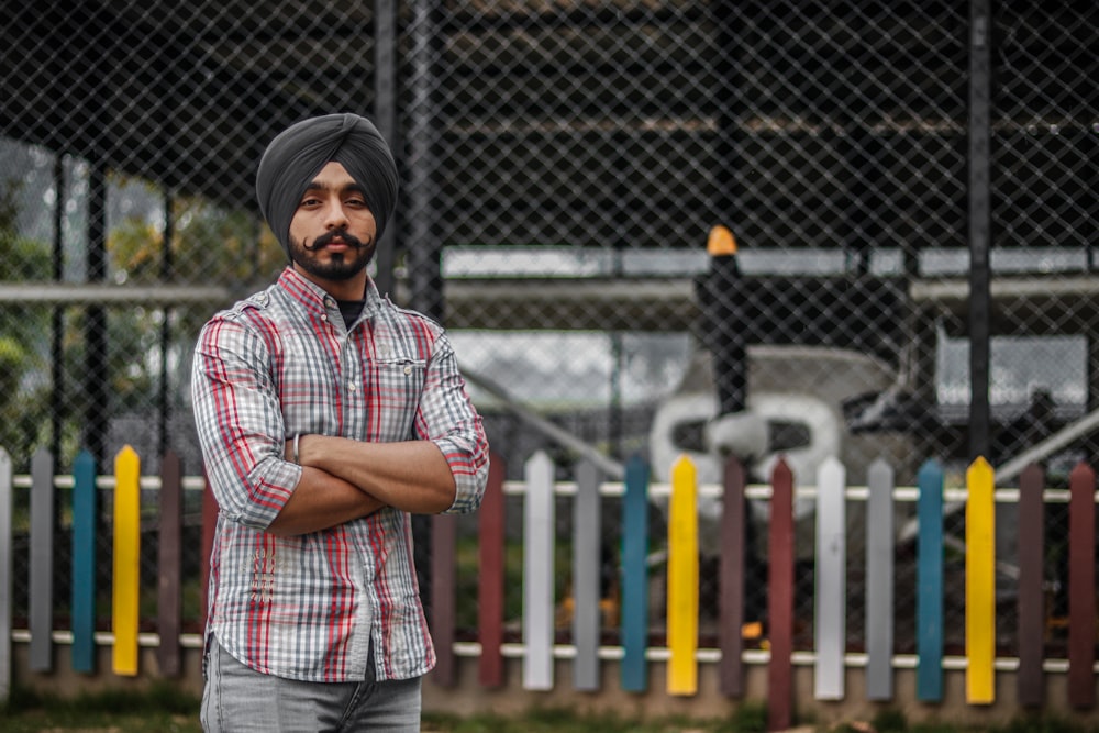 man standing beside the fence