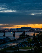 A vibrant cityscape at dusk with people engaging in community activities.