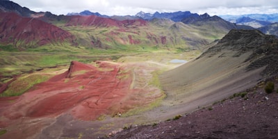 A colorful jigsaw puzzle in progress showing a vibrant landscape with mountains and a sunset.