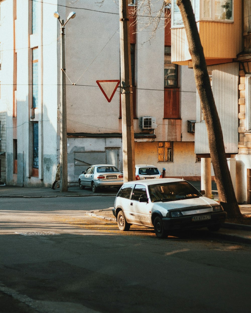 parked white car beside building