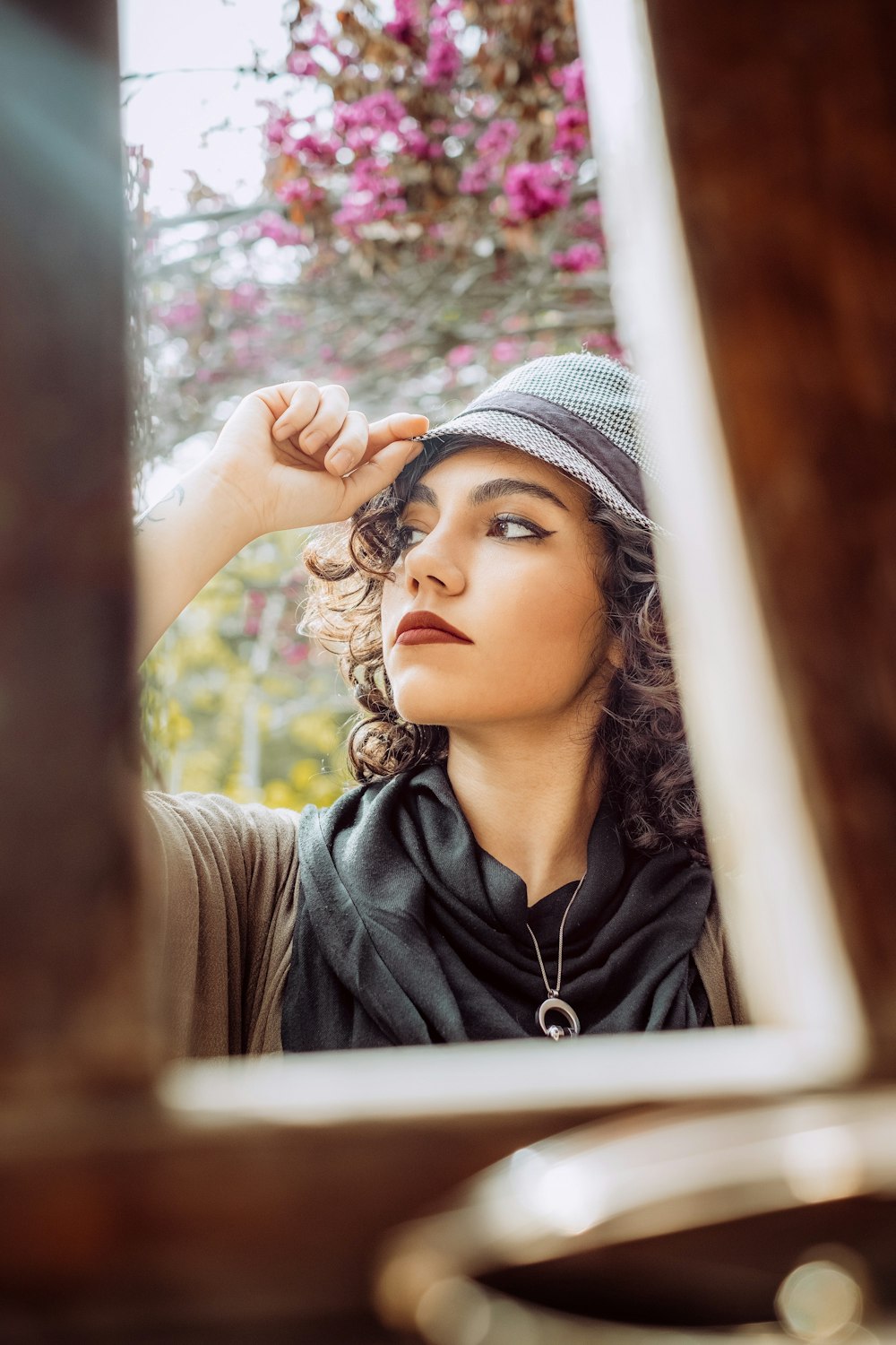 woman wearing black top holding her cap