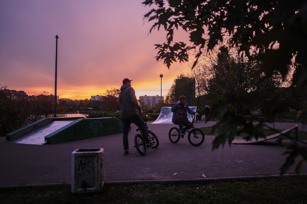 two men riding on BMX bikes