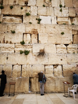 A serene photo of the Western Wall with a small note tucked between the stones