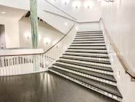 A sleek modern staircase with freshly painted black and white accents highlighting the design.