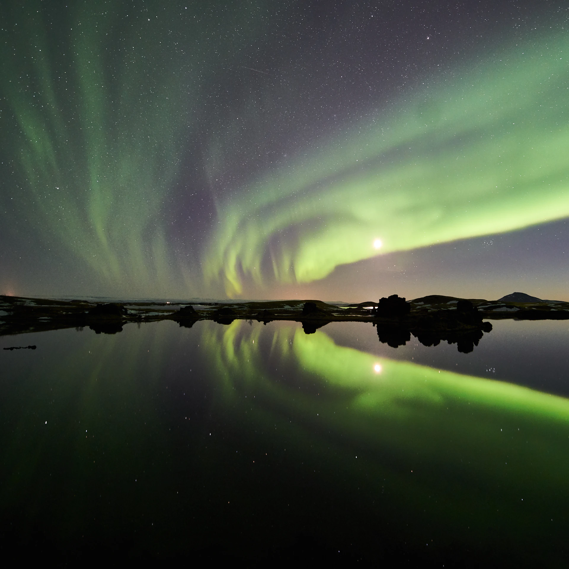 the aurora bore is reflected in the water