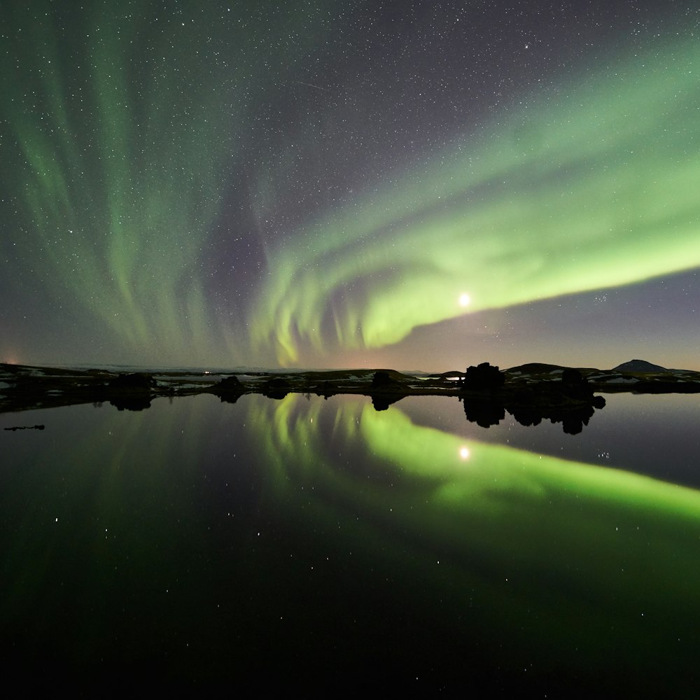 the aurora bore is reflected in the water