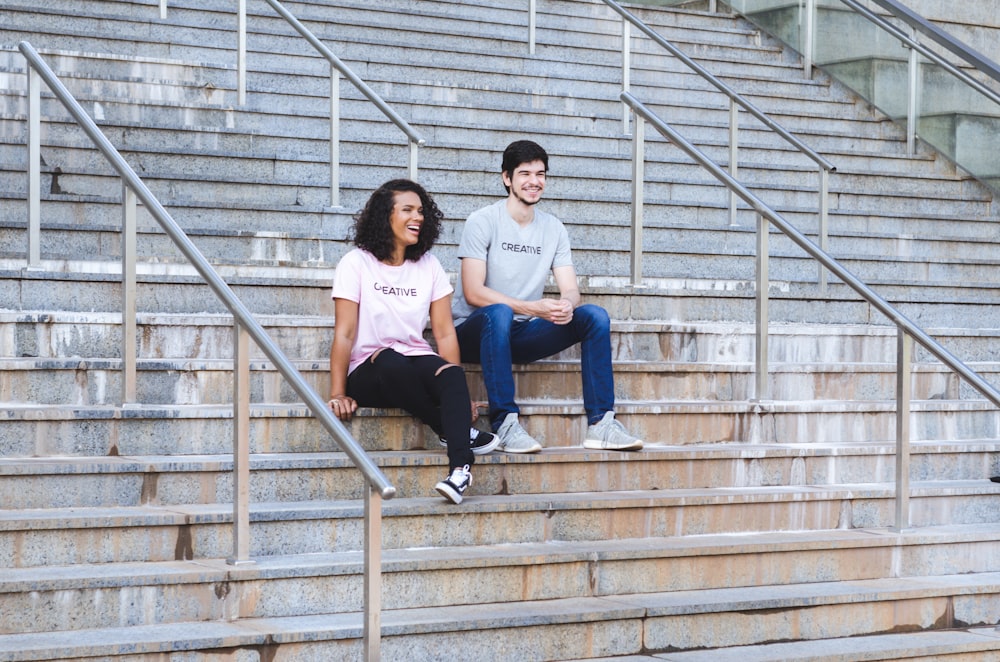 man and woman sitting on stairs