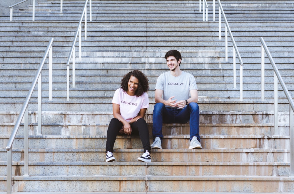 man and woman sitting on stairs