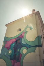 Freshly painted building facade with vibrant colors under sunlight.