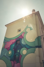 Freshly painted building facade with vibrant colors under sunlight.