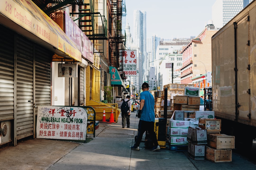 man in blue T-shirt beside boxes