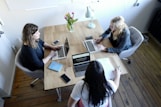 three women sitting and facing each other