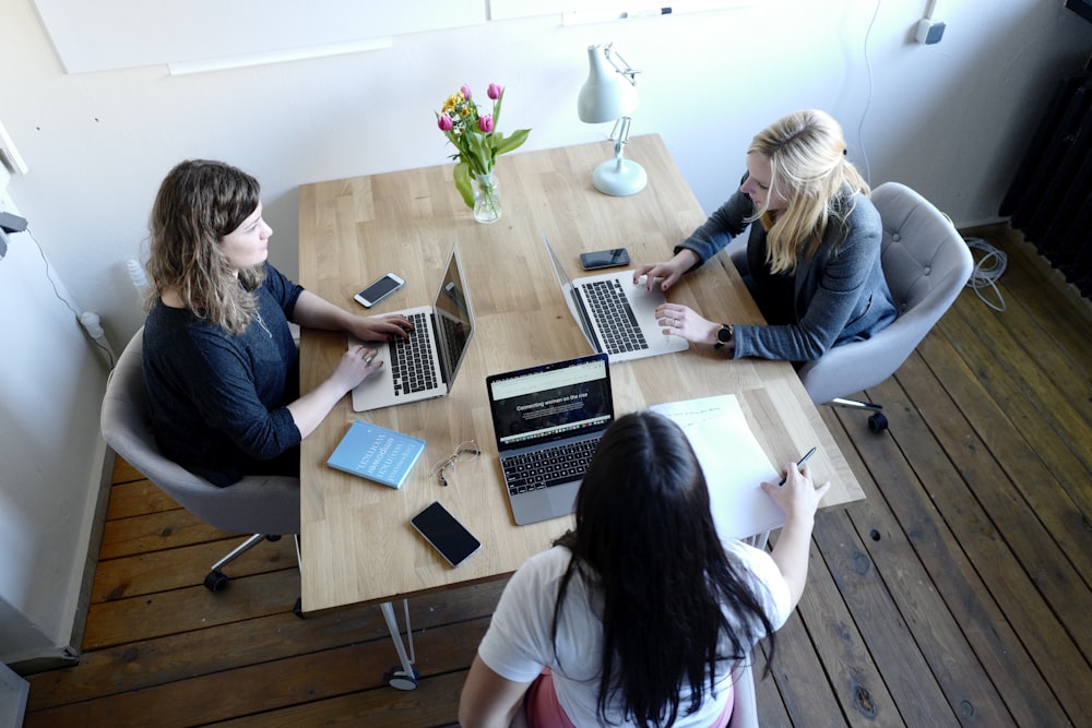 three women sitting and facing each other discussing 