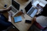 two person using laptops
