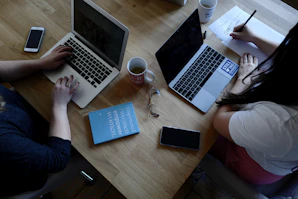 two person using laptops