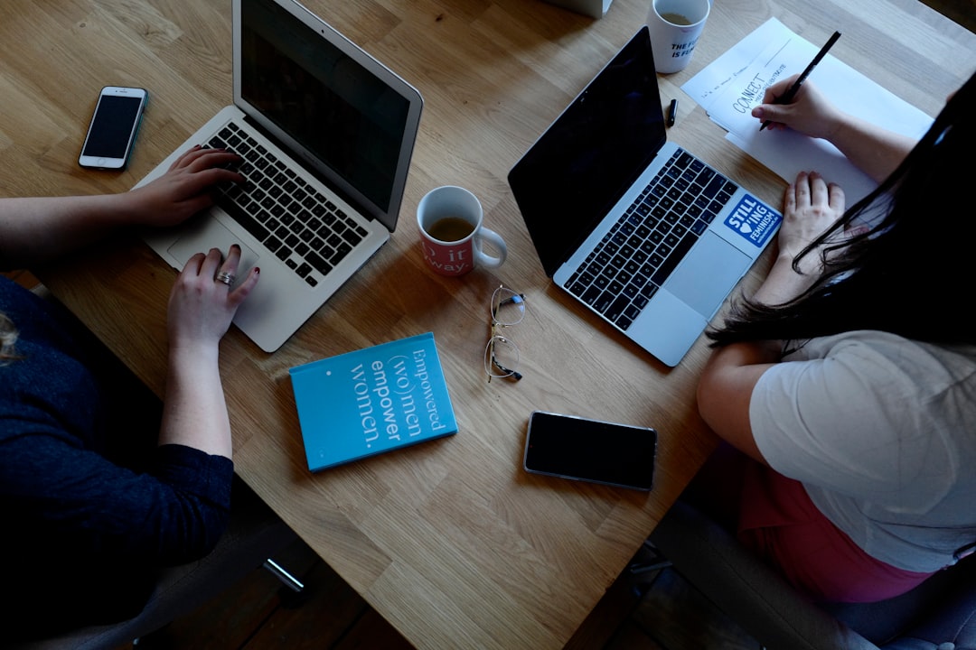 two person using laptops