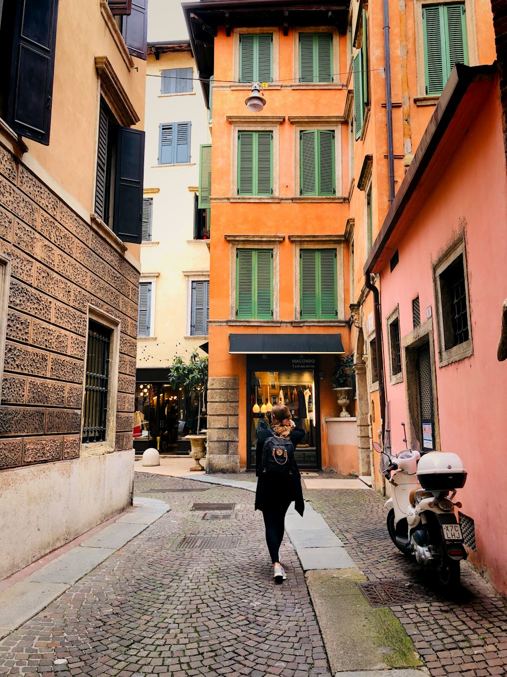 woman walking on alley during daytime