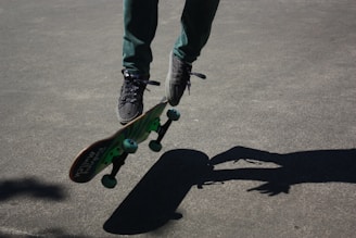 Close-up of a skateboarder performing a trick on a smooth concrete surface.