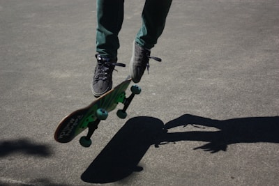 Close-up of a skateboarder performing a trick on a smooth concrete surface.