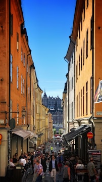 Historic city street bustling with tourists and cafes.