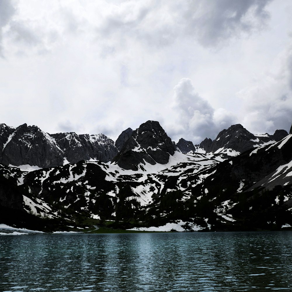 grayscale photography of mountain covered with snow