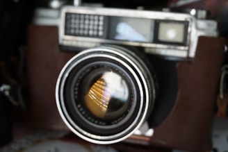 Close-up of a vintage camera lens reflecting soft natural light.