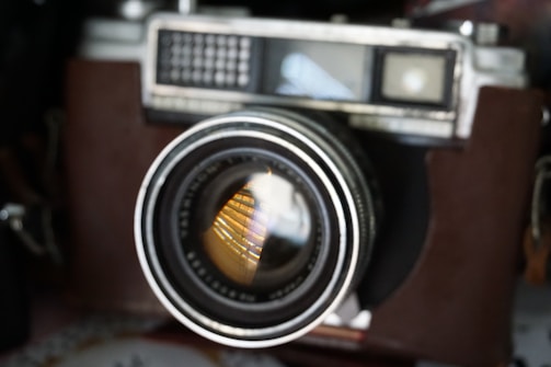 Close-up of a vintage film camera with the signature lapc logo subtly reflected in the lens.