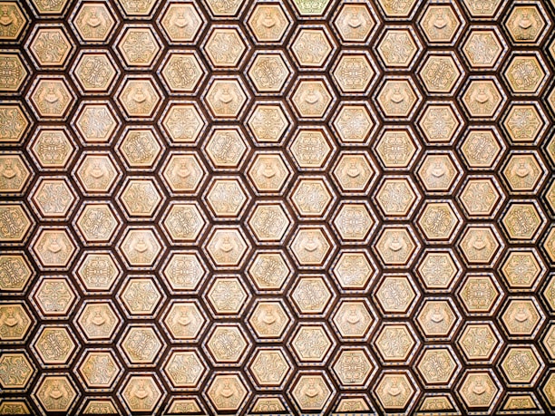 Close-up of a beautifully designed hexagonal pattern inspired by Islamic geometry in deep emerald green and luxury gold.