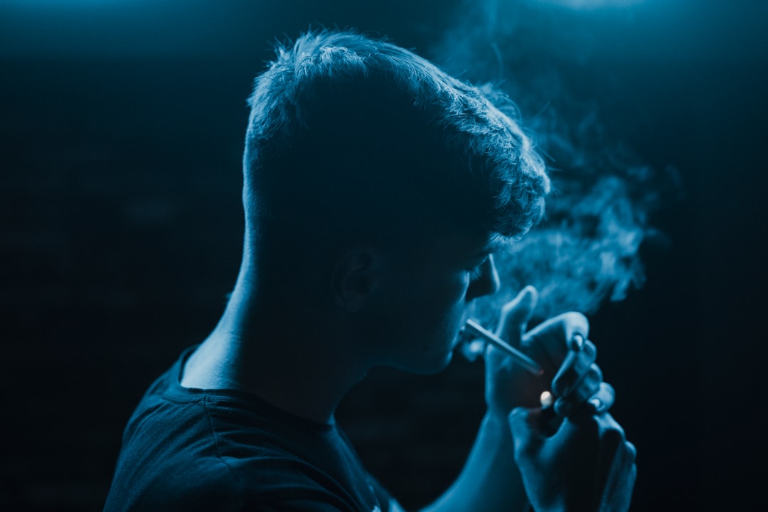 man standing and smoking
