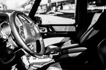 Rich leather car interior with deep shadows and subtle highlights emphasizing texture.