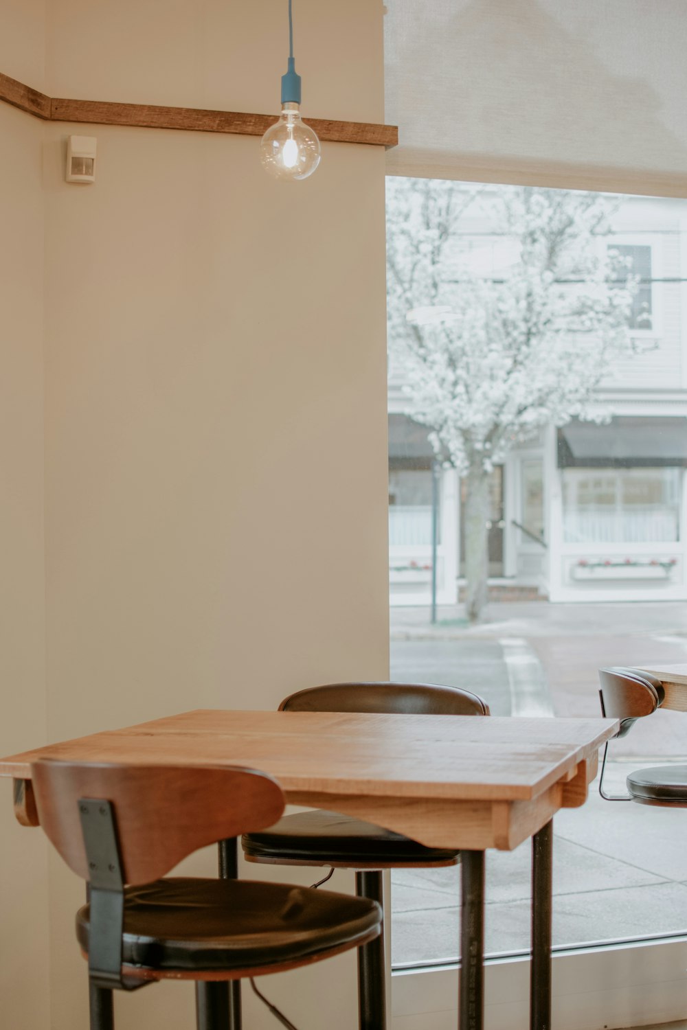 brown wooden table and chairs in room