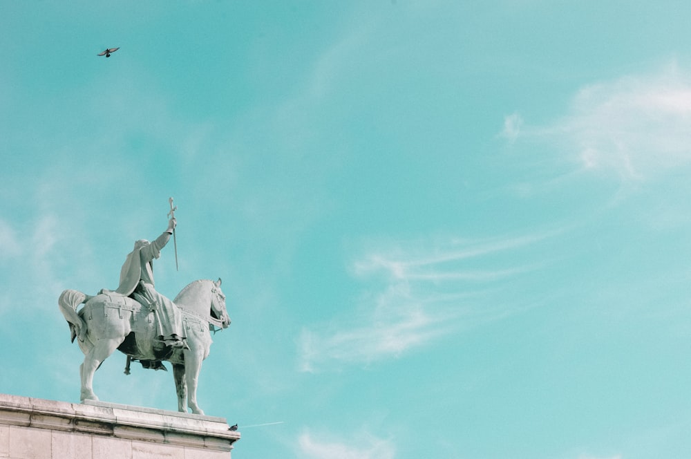 man riding horse statue during daytime