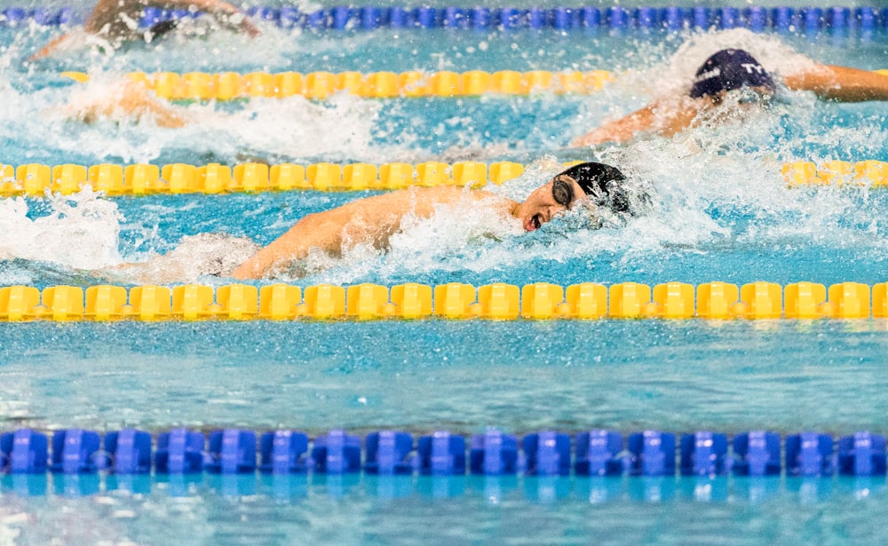 men swimming in pool