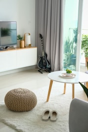 black guitar beside opened door