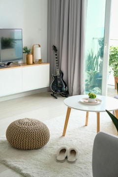 black guitar beside opened door