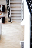 Side view of Easystep device attached securely to a wooden staircase inside a bright living room.