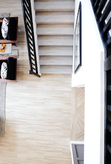 Side view of Easystep device attached securely to a wooden staircase inside a bright living room.