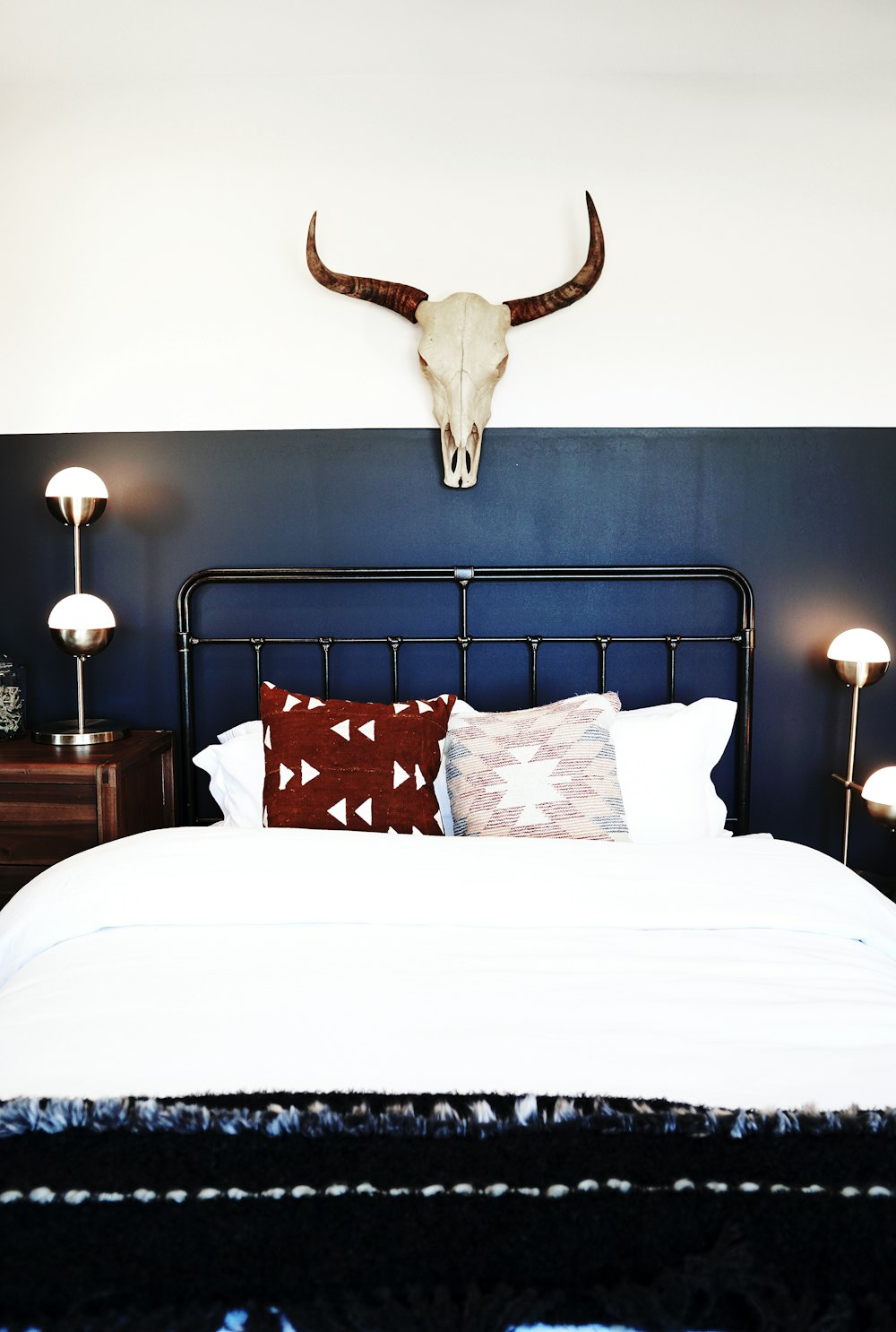 three red and white throw pillows on white bed