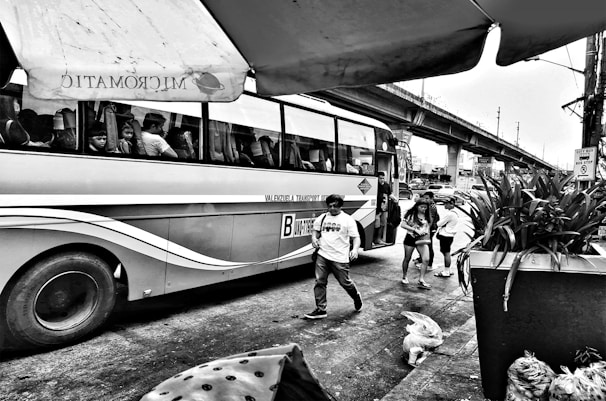 Public transport bus packed with commuters navigating a busy urban street.