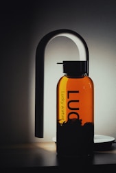 A water bottle being filled at a public refill station with a clean design.