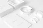 A neat arrangement of wireless earbuds and charging cases on a minimalist table.