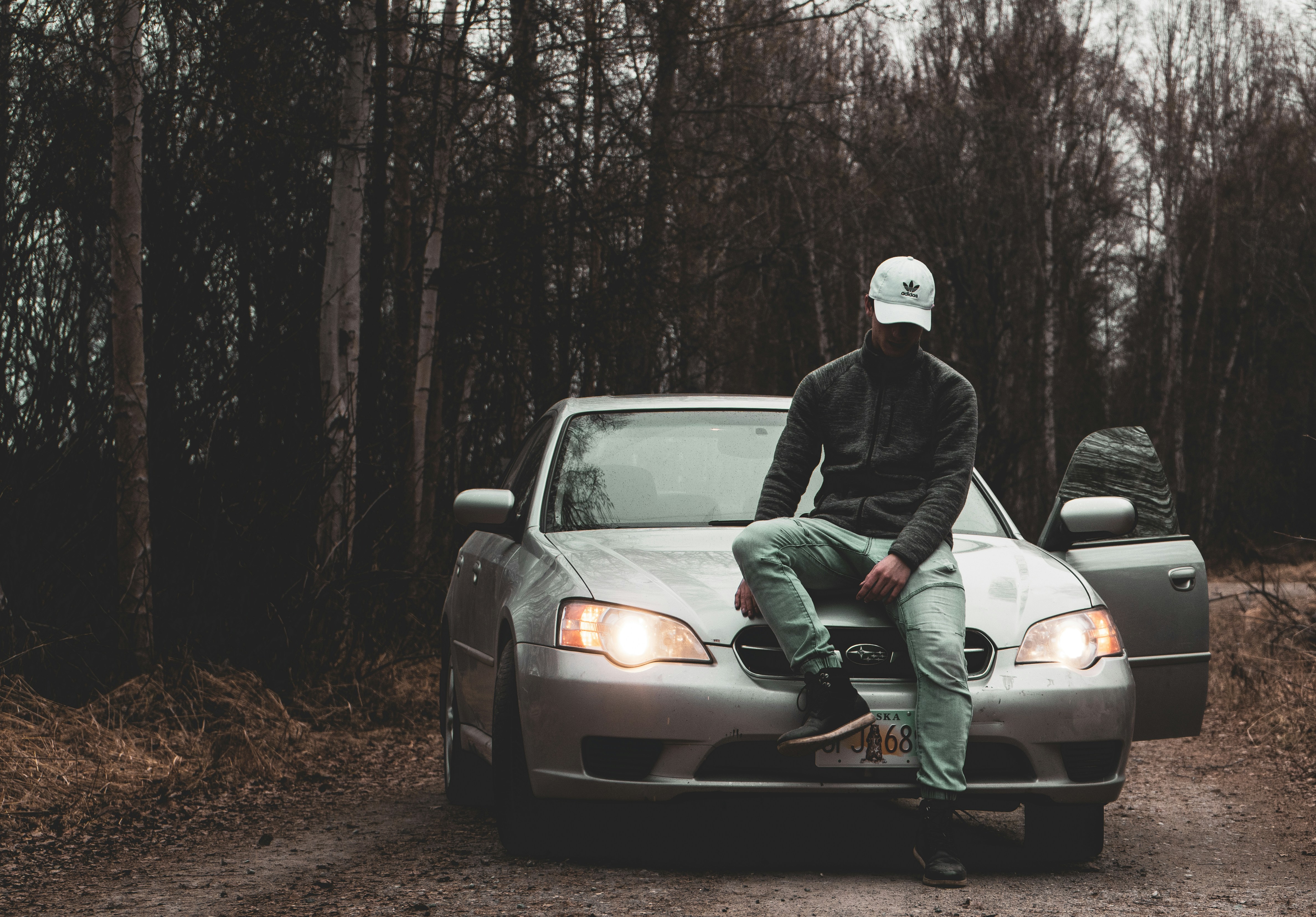 man sitting on car, 