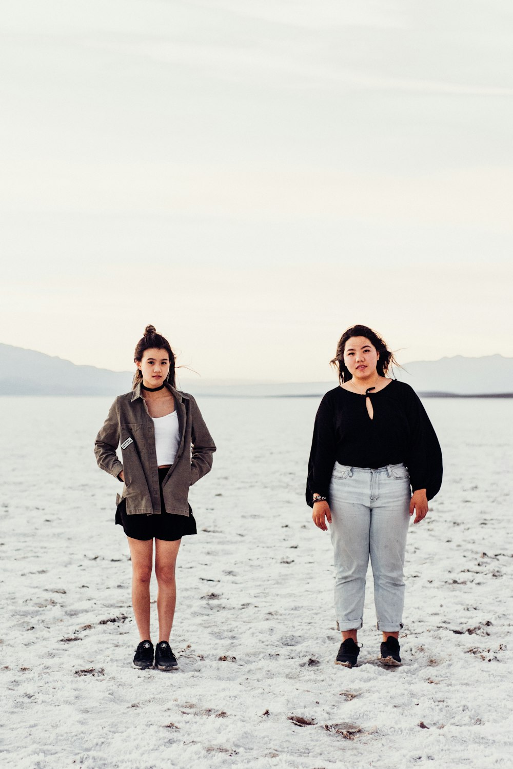 two women standing on pavement