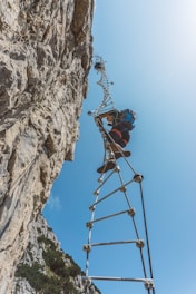 person climbing rope ladder