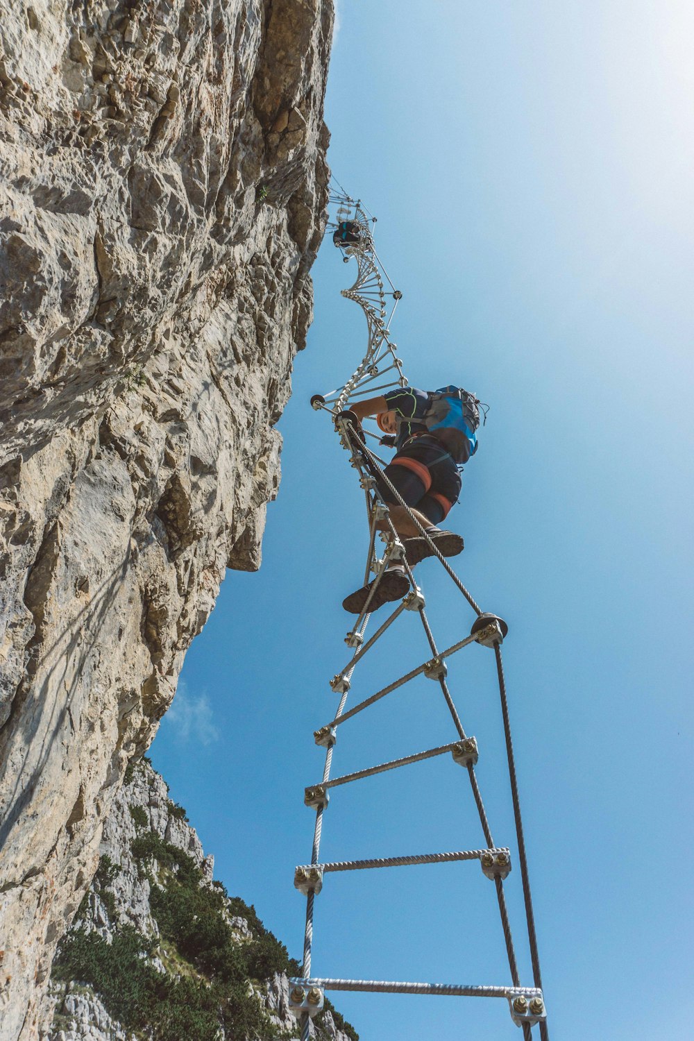 person climbing rope ladder